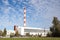 Large, tall electricity thermal power plant red, white color chimney building factory