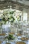 Large, tall flower arrangement  of roses and hydrandeas on a reception table for wedding reception