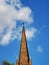 A large tall tower with a clock on the side of a building