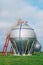 Large tank for the storage of oil and gas on a background of blue sky