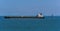 A large tanker steams past the lighthouse in the Singapore Straits in Asia