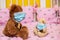 large teddy bear in protective mask and small teddy bear in medical mask sit in cot. Sick animals during epidemic. Coronovirus,