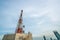 Large telecommunication tower against sky and clouds in background