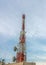 Large telecommunication tower against sky and clouds in background