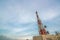 Large telecommunication tower against sky and clouds in background