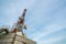 Large telecommunication tower against sky and clouds in background