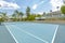 Large tennis court facing north and south to compensate for the