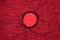 Large Textile mesh hole in the center on red background. Breakthrough concept.