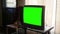 A large thick standard definition green screen generic Television in living room