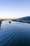 Large-tonnage riverboat cargo ship sails under raised bridge along the Willamette River in the background of evening Portland down