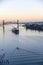 Large-tonnage riverboat cargo ship sails under raised bridge along the Willamette River in the background of Portland down town