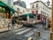 Large tourist bus winds through narrow Montmartre street