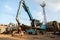 Large tracked excavator working a steel pile at a metal recycle yard. Industrial scrap metal recycling