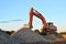 Large tracked excavator works in a gravel pit.