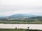 Large tranquil river near the countryside farm and village