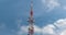 Large transmission tower against fast moving clouds