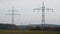 Large transmission towers in the countryside. Different types of electricity pylons in the countryside. Large electricity poles in