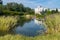 A large transparent decorative lake with a huge number of green flower beds