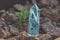 Large transparent mystical faceted crystal of colored blue sapphire, topaz on stone background close-up. Wonderful mineral quartz