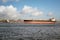 A large transport ship sails through the strait with port