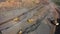 A large truck carries iron ore in the back of a quarry aerial view.