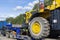 Large truck with a low platform trailer carrying a tractor. A truck for transporting heavy equipment loaded with a large tractor.