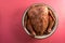 Large turkey in spices in a bowl on a pink background free space