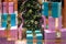 Large turquoise and pink boxes with gifts around the Christmas t
