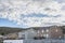 Large two-storey houses with front door decks with a view of mountains and sky