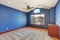 Large unfurnished room with blue interior.