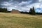 Large unused mountain hotel on the top of grassy hill