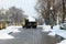 A large utility truck removes snow from a city street in winter. Dnipro city, Dnepropetrovsk,