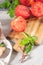 Large variety of tomatoes on rustic kitchen counter. Preparation of tomato sauce with onions and basil