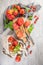 Large variety of tomatoes on rustic kitchen counter. Preparation of tomato sauce with onions and basil