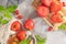 Large variety of tomatoes on rustic kitchen counter. Preparation of tomato sauce with onions and basil