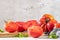 Large variety of tomatoes on rustic kitchen counter. Preparation of tomato sauce with onions and basil