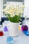 A large vase with daisies in the chemical laboratory, flasks with colored liquids standing on the table