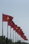 Large Vietnamese and communist flags on a blue sky background and trees