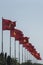 Large Vietnamese and communist flags on a blue sky background and trees