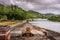 Large view by wide angle on Seine River in France, with excavator Poclain on the dock. Canal boats on the river, parked