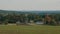 A large village visible in the distance beyond the field