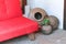 Large vintage decorative clay pots next to a red sofa in the shade