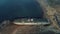 Large vintage ship standing on the the pier surrounded by sea water against the mountain hills and blue sky. Shot. Old