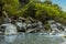 Large volcanic boulders line the river bank of  the Alcantara river near Taormina, Sicily