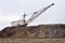 Large walking excavator in anticipation of rolling stock transporting overburden for storage in dumps