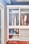 Large wardrobe with matte glass on doors in wooden house