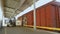 A large warehouse, forklift loads boxes in the freight train. Rail transportation