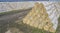 large warehouse of straw bales on the field.