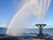Large water fountain spraying mist and casting rainbow