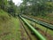 a large water pipe running down the mountains makes for a distinctive scenic view